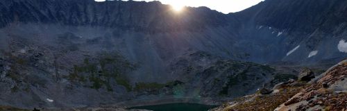 Sun cresting the crown of Rock Lake